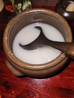 Ozeki Nigori unfiltered sake, cold, served in ceramic bowl and cups - go delicious! at HanGawi in New York City