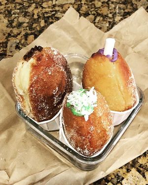 The Chocolate (top l), the Japanese sweet purple yam, and thePandan malasadas.  at SPLIT Bakehouse in La Mesa