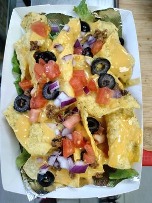 Nacho Supreme! Layers of fresh veggies with Tortilla chips and our popular melted cheese 😋 it's Gluten free* all the way! at Our Vegan Corner in Syracuse