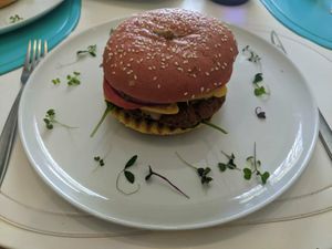 Seitan 'beef' burger with cashew cheese, facon, and more. at Origin Cafe in Noord