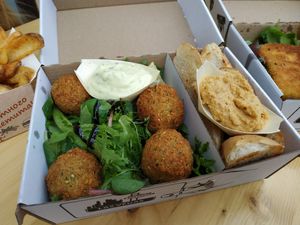 Salad with hummus, tatar sauce, pieces of toast and falafel. All in a take-out box. at Vegánsky Gazda in Trencin