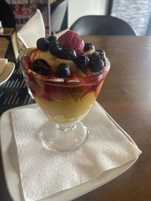 Ice-cream coupe with vanilla/strawberry/mango ice-cream, fresh fruit and strawberry sauce. Really good!  at Vegan Food Bar in Almere