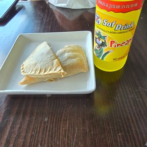 Jamaican vegan patties with a pineapple drink. Very tasty! make sure to order the vegan patties.  at Jamaican Breeze Sports Bar & Grill in Indianapolis