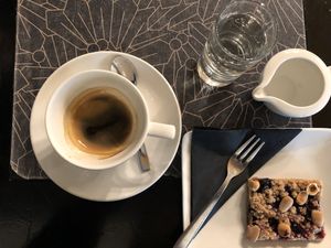 Coffee Americano and vegan berry cake  at Antico Caffè San Marco in Trieste