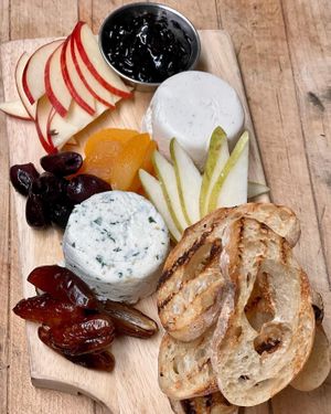 
Share a charcuterie board 
Variations of cashew brie paired with dried apricots, dates, kalamata olives, black cherry jam, fresh fruits, and toasted ciabatta crostini.  at The Organic Grill in New York City