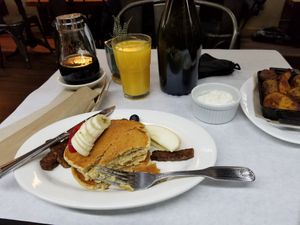 Oat pancakes, homefries, tempeh bacon, and OJ at The Organic Grill in New York City