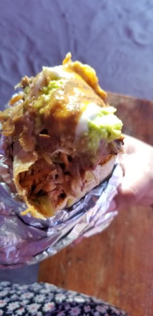 Burrito with all the sauce. Sorry for the blur. Worth it. at Ulu Dos Tres Taco in Zanzibar