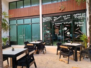 Exterior and interior tables and chairs at Elixir Juice & Bowl Bar in Tulum