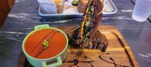 The artist with vegan cheese and a bowl of tomato soup at The Grilled Cheese Gallery in St Augustine