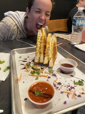 My non-vegan friend eyeing my vegan grilled cheese  at The Grilled Cheese Gallery in St Augustine