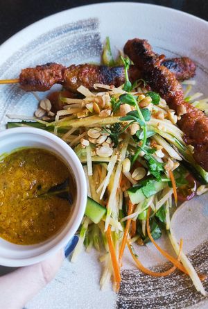 Papaya salad with "chicken" skewers and yummy sauce. at Vegan World Peace by Loving Hut in Reykjavik