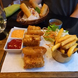 Crispy tofu, onion rings,  chips. Also spring rolls. at Vegan World Peace by Loving Hut in Reykjavik