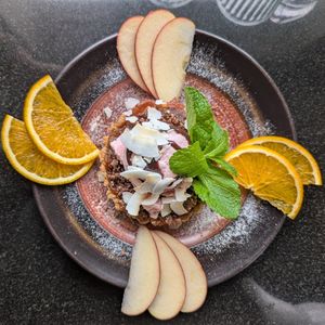 Apple tart with ice cream and fruit at Vegan World Peace by Loving Hut in Reykjavik