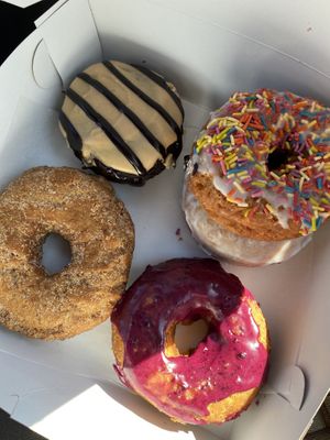 Peanut butter chocolate, cinnamon sugar, vanilla frosted, lavender oat milk glaze, and blueberry😄 at The Donut GroVe in Orono