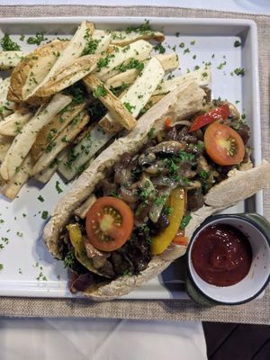 Philadelphia mushroom sandwich, with potato fries. at Mother Earth Vegan Restaurant in Tamarindo