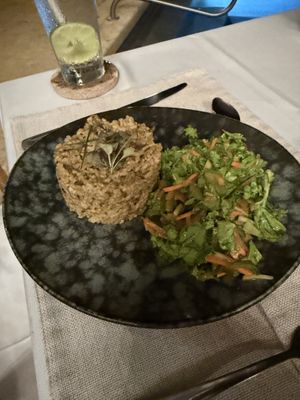 Mushroom risotto with salad  at Mother Earth Vegan Restaurant in Tamarindo