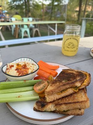 Fresh made hummus with side of veggies (tomatoes, carrots, celery) and vegan grill cheese   at Cultured South Fermentation Co in Atlanta