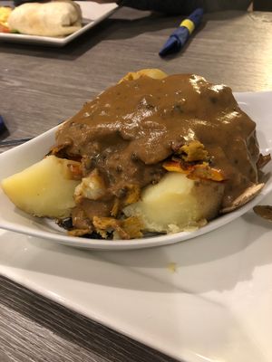 Baked potato with Seitin, veg and pepper sauce  at Harry's Place CIC in Ballynahinch