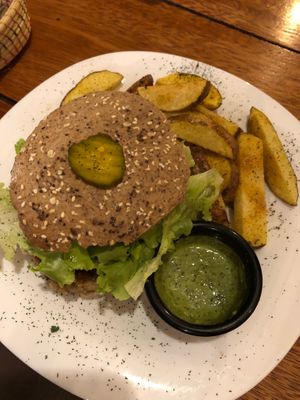 Veggie GF burger with homemade GF bun and potatoes with pesto and spicy sauces  at Uku Pacha in Quito
