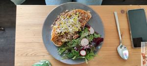 Spiced carrot (toasted sourdought topped with a baked carrot spread sprinkled with assorted spices (Fennel, cumin, walnuts) at Mana Food - Moabit in Berlin