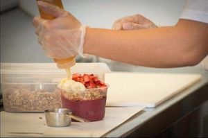 Acai bowls with granola, strawberry, banana and honey on top at Pure Juice & Smoothie Lounge in Concord