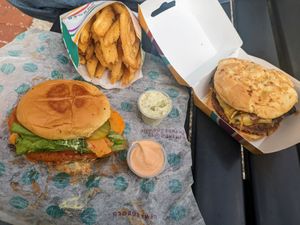 Spicy chick'n burger, steakhouse burger, herb fries, garden herb aioli, and spicy aioli. at PLNT Burger in Alexandria