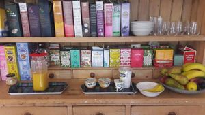 sorts of tea, cornflakes, fresh juice, fruits and soy joghurt at Claymore Vegetarian Guest House in Edinburgh