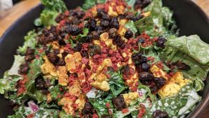 Kale Caesar Salad -
kale and romaine, house caesar dressing,
garlic croutons, red onions, fried capers at Burger Fiancé in Montreal