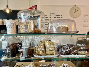 Vegan cakes- on top of the counter and the first shelf   at Cup & Cone in Inverness