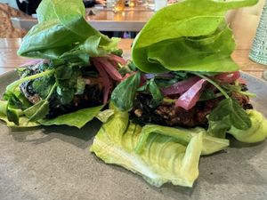 HARVEST SLIDERS (made vegan by lettuce wrap, no milk bun) 
carrot-cashew patty, almond satay, pea sprouts, pickled red onion, milk bun  at Flamingo's Lazeaway Club in Santa Rosa