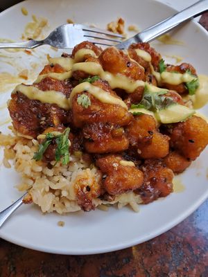 AMAZING! Korean Fried Cauliflower with coconut pineapple rice.  Just the right amount of spice. This place never disappoints. at Norwood's Restaurant & Treehouse Bar in New Smyrna Beach