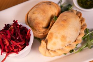 Vegan empanadas. One is a sweet potato kale. The other is a beyond "meat" empanada. Served with beet slaw and house chimichurri sauce.  at Buena Onda Cafe in St Augustine
