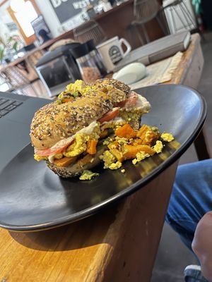 Crazy good bagel sandwich made vegan with tofu scrambleed eggs  at Buena Onda Cafe in St Augustine