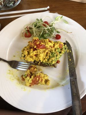 Half eaten avo, tofu scramble and tomato on sourdough   at Nang Sabai Cafe Artisan Bakery in Koh Samui