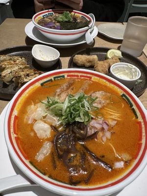 Spicy ramen (close), garlic oil ramen (far), gyoza and deep fried meat entrees    at Vegan Bistro Jangara in Tokyo