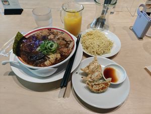 Creamy thick soup with extra soy meat, noodles and gyoza set with orange juice at Vegan Bistro Jangara in Tokyo