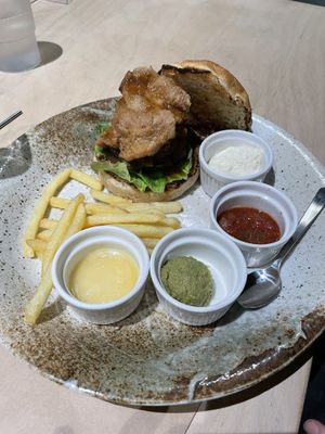 Burger with extra portion of soy meat. So many sauces and hardly any chips to dip in them 🥲  at Vegan Bistro Jangara in Tokyo