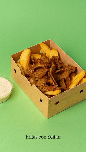 A serving of French fries with marinated seitan and soy yogurt sauce. at Good Shit, Vegan Kebabs in Barcelona
