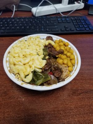 Mac n cheese, collard greens, jerk chicken, curry chickpeas on top at Uptown Veg in New York City