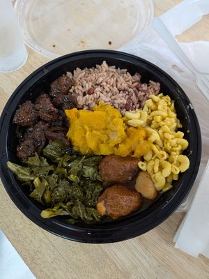Jerk, rice n peas, Mac, oxtails, greens, and pumpkin at Uptown Veg in New York City
