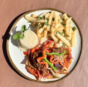 Lomo Saltado:
Juicy strips of jackfruit steak stir-fried with tomato, red onion, fresh garlic & cilantro. Served with white rice & lightly seasoned fries. at El Tamarindo in Washington