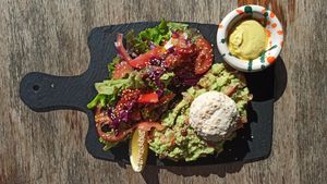 Brunch special - Smashed Avo Toast on Black Rye. Side of fresh salad, vegan poached egg. at Foam and Fork in Gzira
