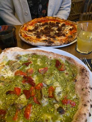 umami pizza - mince, mushrooms, oregano and mia pizza - tomatoes, sun dried tomatoes, artichokes, pistachios  at Marcus Pizze Amore in Paris