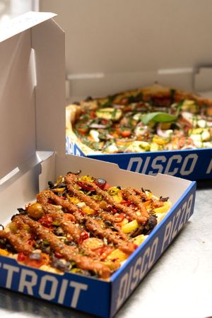 Detroit Style pizza in the front, Naples Style pizza in the back at Disco Pizza in Luzern