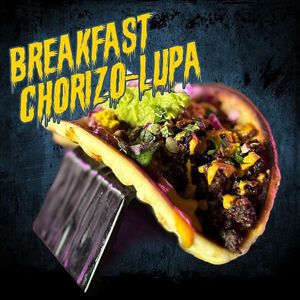 Breakfast Chorizo-Lupa. Tofu scramble, chorizo seitan, enchilada sauce, cheese, guacamole, diced onions, and cilantro on a grilled pita shell.    at Terror Tacos in St Louis