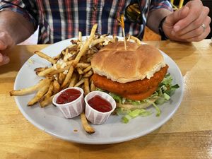 The vegan Buffalo unchicken sammy with garlic fries.  at Golden West Cafe in Baltimore