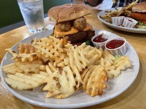 The vegan chick’n Supremo with waffle fries. The sandwich has vegan  mozzarella sticks on it. It was very good. I would order it again.  at Golden West Cafe in Baltimore