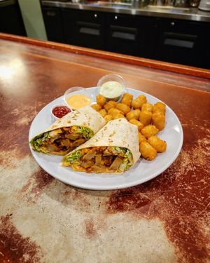 Vegan Buffalo Chick'n Caesar Wrap with Tots at Golden West Cafe in Baltimore