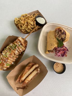 Street dog, short rib wrap, wonton cheese sticks, fried peppers at Sunny's Backyard in Austin