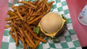 Cheeseburger on a gluten free bun with sweet potato fries. at Eliza's Vegan Café in Florence